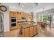 Modern kitchen with an island, granite countertops, stainless steel appliances, and a view to the dining area at 12140 Pawleys Mill Cir, Raleigh, NC 27614