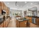 Open kitchen featuring an island with seating, stainless steel appliances, and views to the dining area at 12140 Pawleys Mill Cir, Raleigh, NC 27614