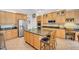 Spacious kitchen with stainless steel appliances, a large island and custom wooden cabinetry at 12140 Pawleys Mill Cir, Raleigh, NC 27614