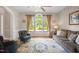 Inviting living room with a large arched window that overlooks the front lawn at 12140 Pawleys Mill Cir, Raleigh, NC 27614