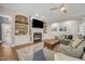 Inviting living room features a fireplace, built-in bookshelves, and a comfortable sectional sofa at 12140 Pawleys Mill Cir, Raleigh, NC 27614