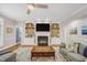 Spacious living room featuring a fireplace, built-in bookshelves, and hardwood floors at 12140 Pawleys Mill Cir, Raleigh, NC 27614