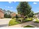 Side view of a well-maintained home with mature landscaping, a fire hydrant, and basketball court at 12140 Pawleys Mill Cir, Raleigh, NC 27614