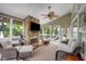 Inviting sunroom with stone fireplace, comfortable seating, and natural light at 12140 Pawleys Mill Cir, Raleigh, NC 27614