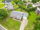 Aerial view of a meticulously landscaped property featuring a driveway, front porch, and a manicured lawn at 124 Roscommon Ln, Clayton, NC 27520