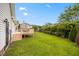 Backyard featuring deck, privacy hedges, and green grass at 124 Roscommon Ln, Clayton, NC 27520