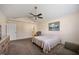 Spacious primary bedroom featuring seating area, ceiling fan and en suite bathroom at 124 Roscommon Ln, Clayton, NC 27520