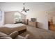 Bedroom featuring carpet, ceiling fan, and view into adjoining room at 124 Roscommon Ln, Clayton, NC 27520
