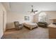 Large main bedroom with seating area, ceiling fan, and picture window at 124 Roscommon Ln, Clayton, NC 27520