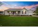 Charming single-story home featuring a welcoming front porch and a well-manicured lawn at 124 Roscommon Ln, Clayton, NC 27520