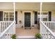 Inviting front porch featuring a well-decorated entrance and classic architectural details at 124 Roscommon Ln, Clayton, NC 27520