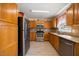 Kitchen features stainless steel appliances, wood cabinets and granite countertops at 124 Roscommon Ln, Clayton, NC 27520