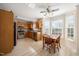Bright kitchen features stainless appliances, wood cabinets and an eat-in dining area with natural light at 124 Roscommon Ln, Clayton, NC 27520