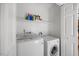 Laundry room features modern appliances and storage shelf at 124 Roscommon Ln, Clayton, NC 27520