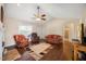 Spacious living room featuring comfortable seating and direct access to a full bathroom at 124 Roscommon Ln, Clayton, NC 27520