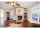 Cozy living room featuring a fireplace with built-in shelves and beautiful hardwood floors at 124 Roscommon Ln, Clayton, NC 27520