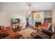 Comfortable living room featuring a fireplace with built-in shelves, hardwood floors, and cozy furniture at 124 Roscommon Ln, Clayton, NC 27520