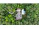 Stunning aerial view of a secluded home featuring a pristine pool, nestled amidst lush greenery and mature trees at 131 Lavinia Ln, Chapel Hill, NC 27516