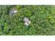 An aerial view of the property including home, pool, driveway and surroundings of lush trees and greenery at 131 Lavinia Ln, Chapel Hill, NC 27516