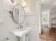 Elegant bathroom with a pedestal sink, wainscoting, and bright natural light at 131 Lavinia Ln, Chapel Hill, NC 27516