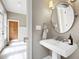 Bright powder room with pedestal sink, round mirror, and neutral paint at 131 Lavinia Ln, Chapel Hill, NC 27516