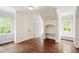 Charming bedroom featuring hardwood floors, wainscoting, built-in shelves, and bright natural light at 131 Lavinia Ln, Chapel Hill, NC 27516
