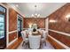 Elegant dining room boasts hardwood floors, refined wallpaper, and a chandelier at 131 Lavinia Ln, Chapel Hill, NC 27516