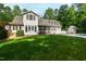 Expansive backyard showcasing the home's exterior, lush lawn, pool, and outbuilding at 131 Lavinia Ln, Chapel Hill, NC 27516