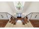 Grand foyer with a staircase, iron railings, and chandelier, setting an elegant tone at 131 Lavinia Ln, Chapel Hill, NC 27516