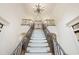 Grand foyer with staircase, iron railings, and soaring ceilings illuminated by a beautiful chandelier at 131 Lavinia Ln, Chapel Hill, NC 27516