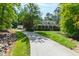 Attractive home featuring a long driveway, well-maintained lawn, and a welcoming front porch at 131 Lavinia Ln, Chapel Hill, NC 27516
