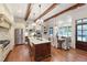 Spacious kitchen with stainless steel appliances, wooden beams, and adjacent dining area at 131 Lavinia Ln, Chapel Hill, NC 27516