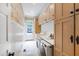 Bright laundry room with modern appliances, tile flooring, and cabinet storage at 131 Lavinia Ln, Chapel Hill, NC 27516