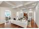 Open-concept living room featuring a coffered ceiling, hardwood floors, and neutral color palette at 131 Lavinia Ln, Chapel Hill, NC 27516