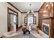 Elegant living room featuring a fireplace, hardwood floors, and stylish furniture with natural light at 131 Lavinia Ln, Chapel Hill, NC 27516