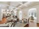 Bright living room with hardwood floors, coffered ceiling, and open concept design leading to the kitchen at 131 Lavinia Ln, Chapel Hill, NC 27516