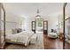 Stunning main bedroom with wood floors, chandelier, ensuite bathroom, and custom details at 131 Lavinia Ln, Chapel Hill, NC 27516
