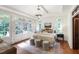 Bright main bedroom with a chandelier, hardwood floors, and access to a private outdoor space at 131 Lavinia Ln, Chapel Hill, NC 27516