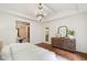 Main bedroom boasts a chandelier, wood floors, and a wooden dresser, creating an airy atmosphere at 131 Lavinia Ln, Chapel Hill, NC 27516