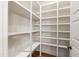 Walk-in pantry with custom shelving and lighting offers lots of storage at 131 Lavinia Ln, Chapel Hill, NC 27516