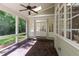 Screened in porch with ceiling fan, brick floor and outdoor living space at 131 Lavinia Ln, Chapel Hill, NC 27516
