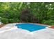 Backyard pool surrounded by lush greenery and patio space at 131 Lavinia Ln, Chapel Hill, NC 27516