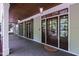 Inviting porch with dark wood ceiling, sconces, and multiple glass-paned doors at 131 Lavinia Ln, Chapel Hill, NC 27516