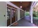 Charming porch featuring dark wood ceiling, sconce lighting, and glass doors at 131 Lavinia Ln, Chapel Hill, NC 27516