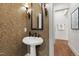 Cozy powder room featuring a pedestal sink, antique-style sconces, and decorative wallpaper at 131 Lavinia Ln, Chapel Hill, NC 27516