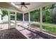 Inviting screened porch with brick flooring, ceiling fan, and a view of the backyard pool at 131 Lavinia Ln, Chapel Hill, NC 27516