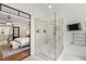 Contemporary bathroom with large glass shower and adjacent main bedroom with chandelier at 131 Lavinia Ln, Chapel Hill, NC 27516