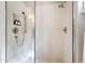 Tiled shower with glass doors, built-in bench, and modern fixtures at 131 Lavinia Ln, Chapel Hill, NC 27516