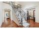 Elegant foyer featuring a grand staircase with wrought iron railings and hardwood floors at 131 Lavinia Ln, Chapel Hill, NC 27516