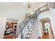 A grand staircase with detailed iron railings and a chandelier creates a stunning focal point at 131 Lavinia Ln, Chapel Hill, NC 27516